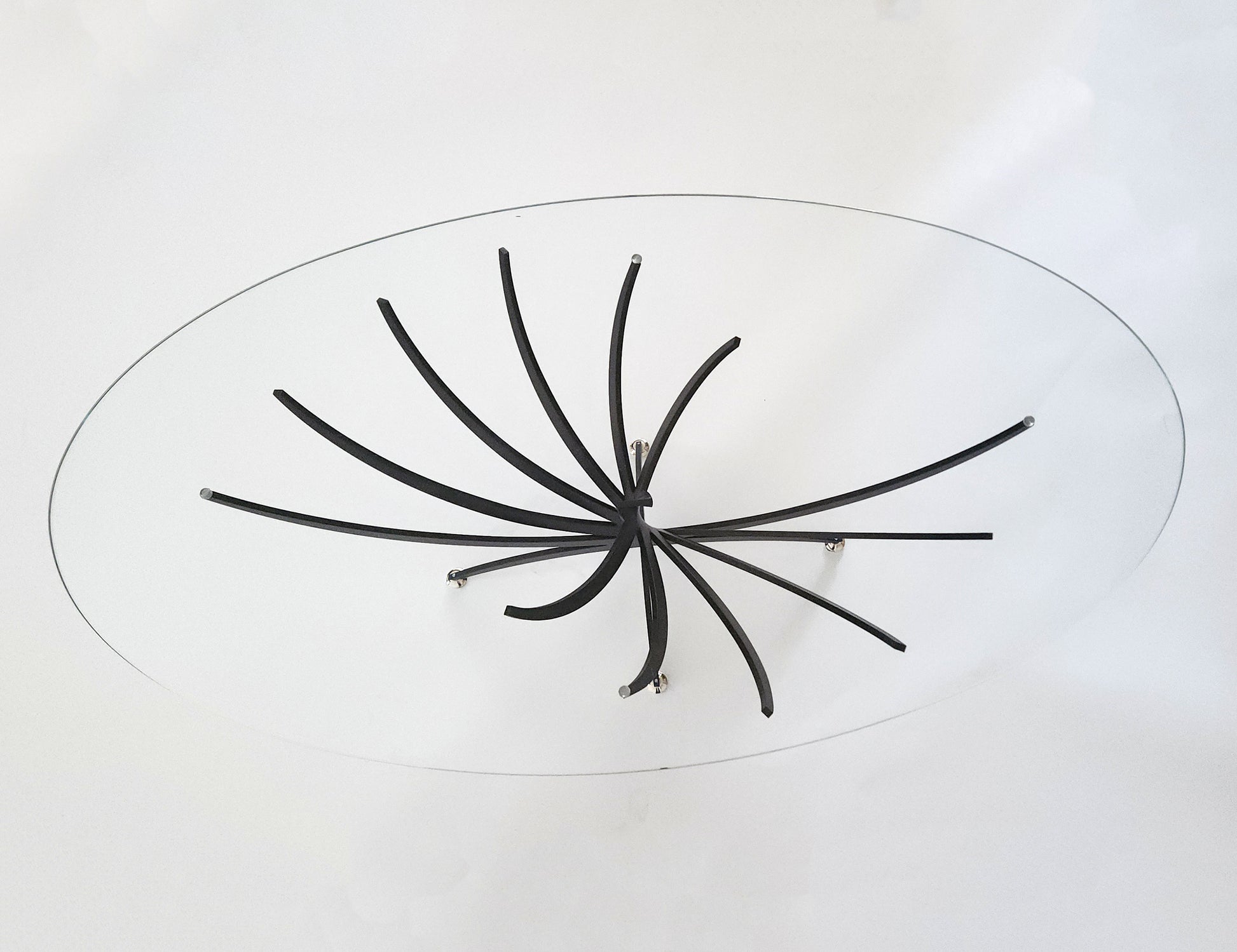 Serge Mouille Twisted Table with glass top and metal base painted in black aluminum - top view