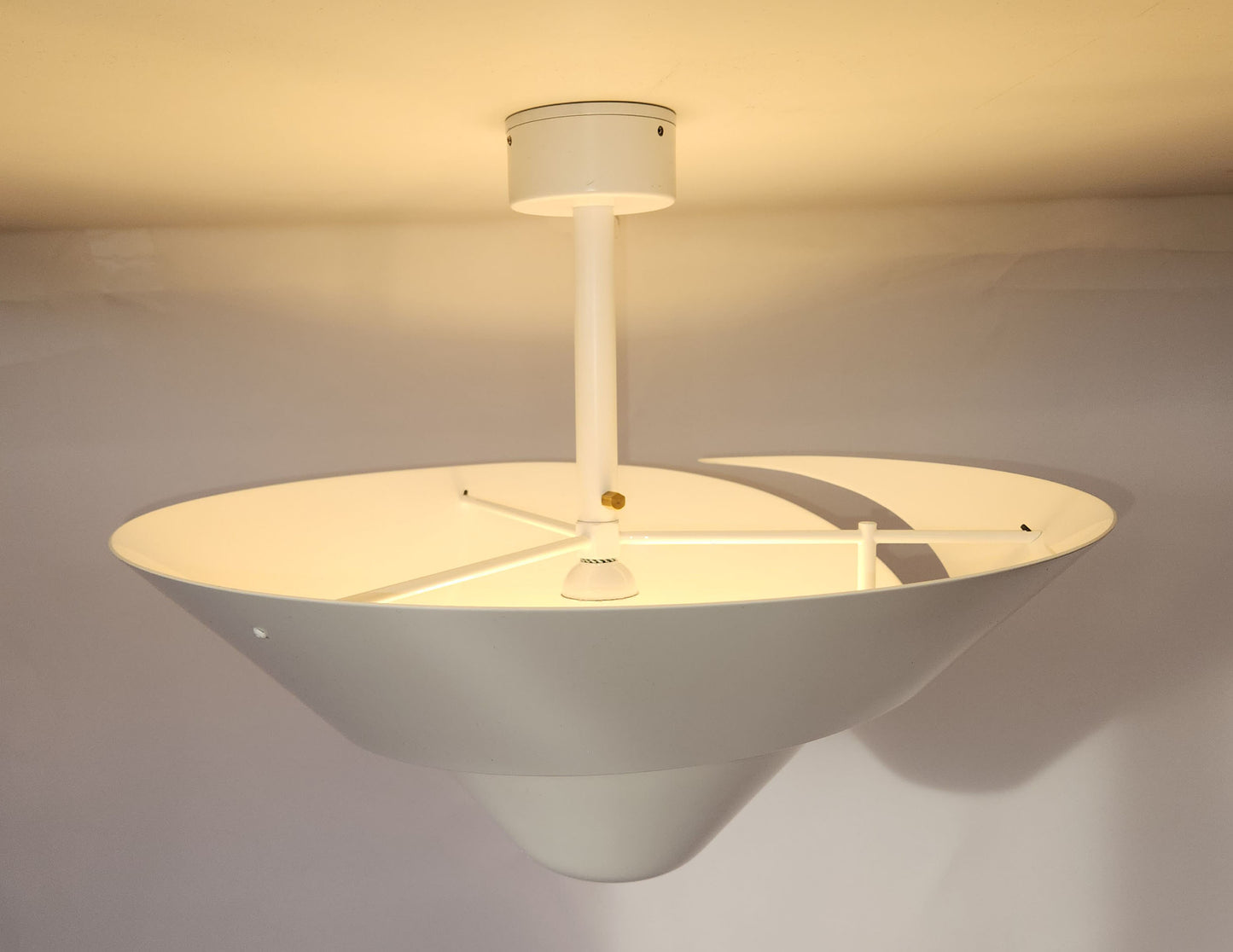 White Serge Mouille Medium Snail Ceiling Lamp Illuminating the Ceiling - Profile View