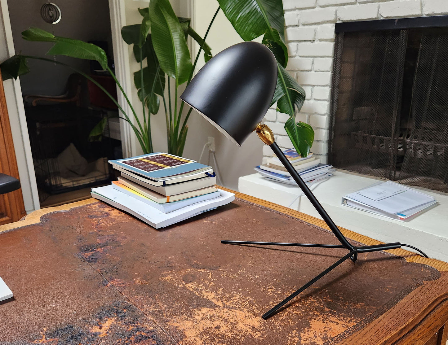 Black Serge Mouille Cocotte Desk Lamp on a desk - Profile View
