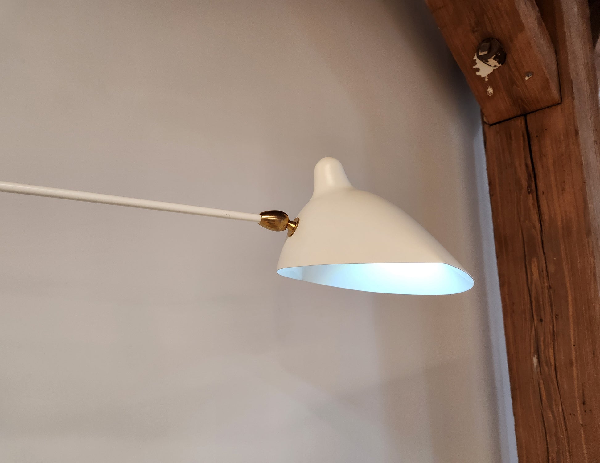 White Serge Mouille Rotating Sconce closeup of shade and brass connector