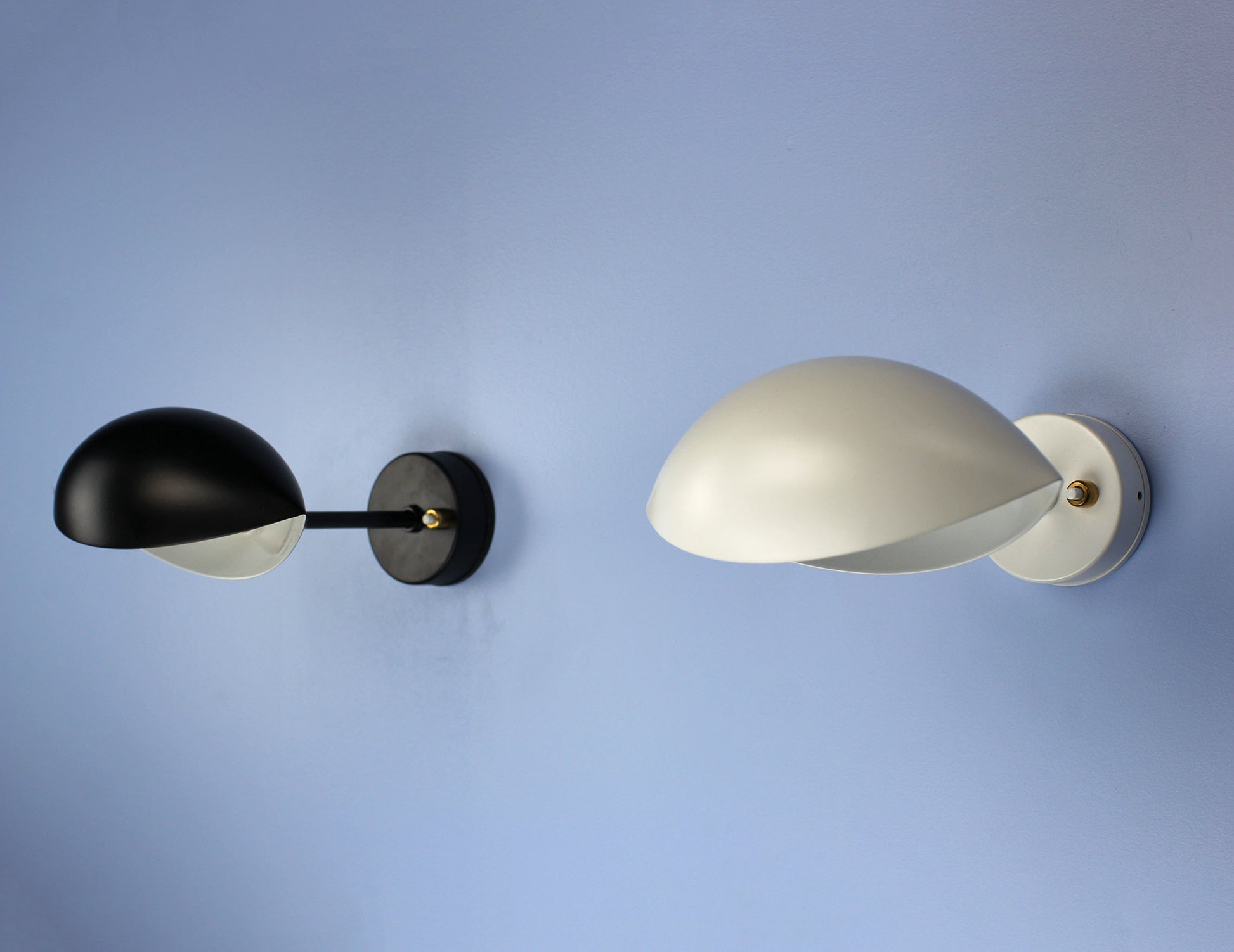 Pair of Serge Mouille Eye Sconces  (1 black and 1 white) with downward illumination