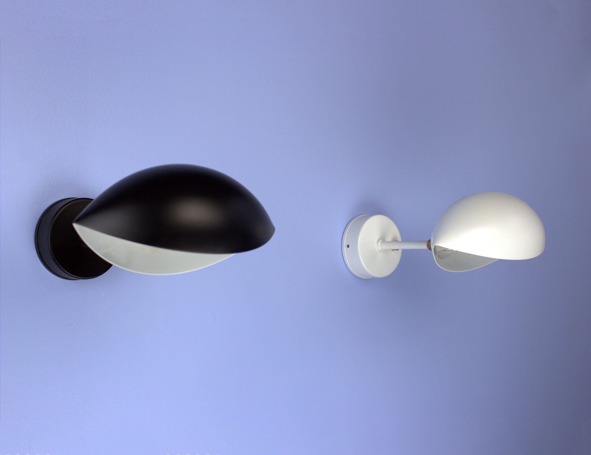 Pair of Serge Mouille Eye Sconces on blue wall