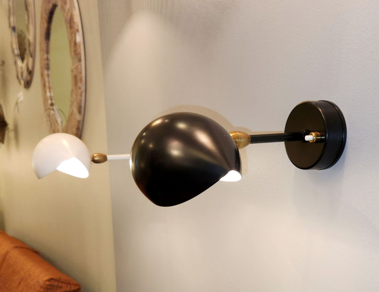 Pair of Serge Mouille Eye Sconces shown at an exhibition