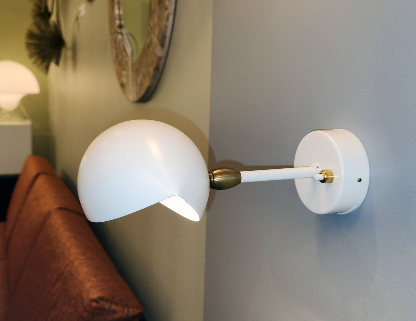 white Serge Mouille Eye Sconce shown in showroom