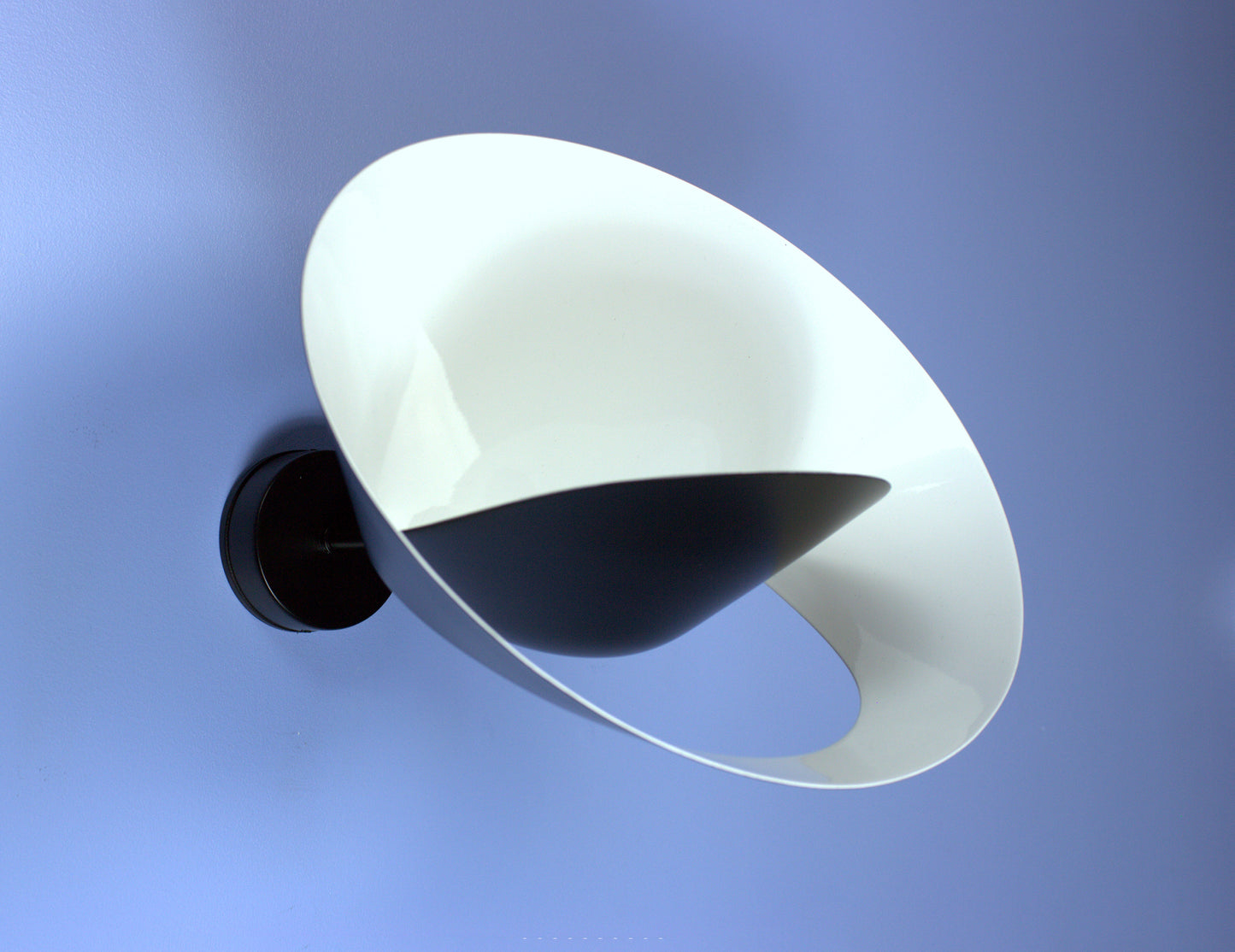 Black Serge Mouille Saturn Sconce on a blue wall
