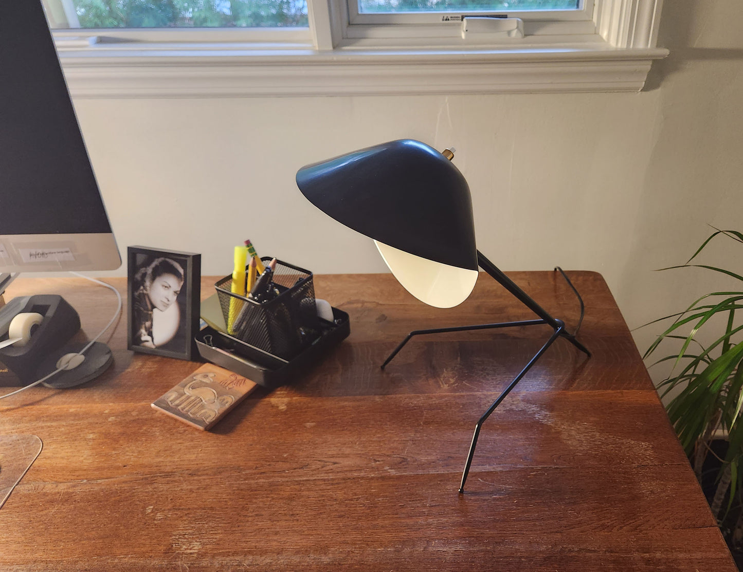 Black Serge Mouille Tripod Desk Lamp on a desk - SergeMouilleUSA